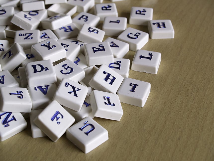 Scrabble pieces over wood background.